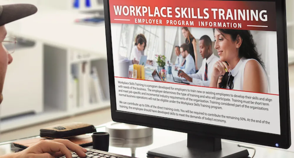 Man looking at Workplace Skills Training Info on Computer