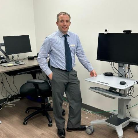 image of a person standing beside a computer area
