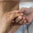 Health care worker holding elderly woman&#039;s hand