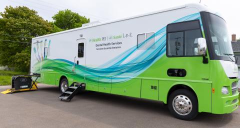 The green and white mobile dental bus