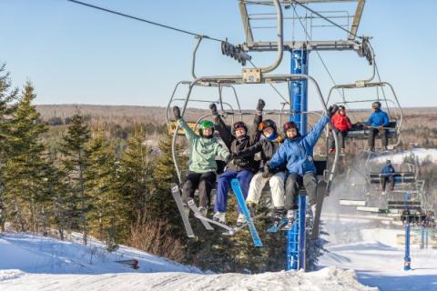 image of people on a ski chair lift during the winter