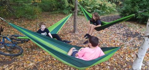 Children sitting in hammocks