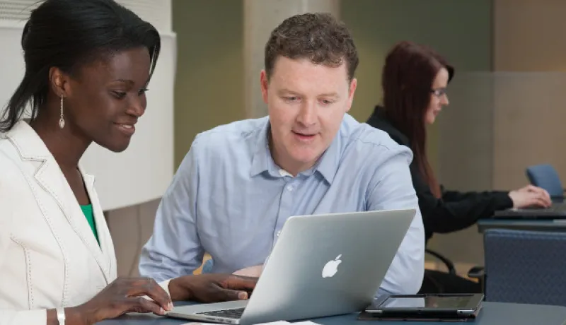 people looking at a computer