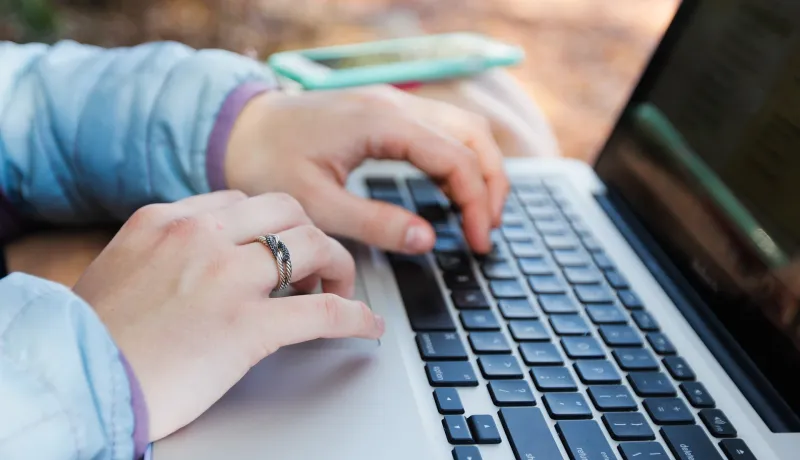 Image of person typing on a computer