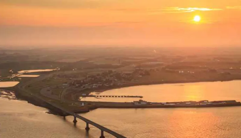 Aerial view of sun setting over Confederation Bridge looking toward Borden-Carleton
