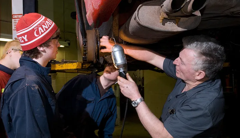 Apprentices learning about auto mechanics