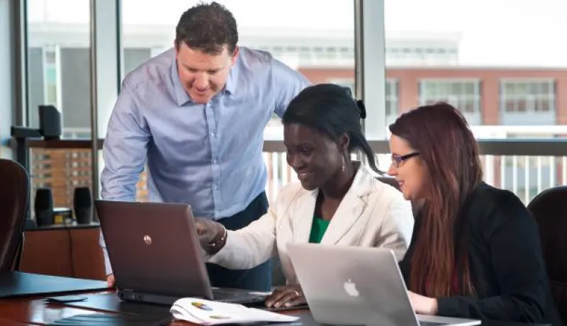 people looking at a computer