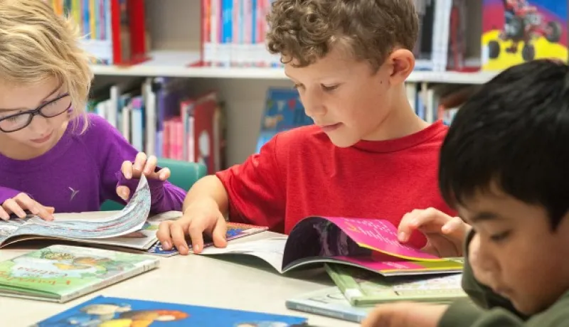 children reading at a table