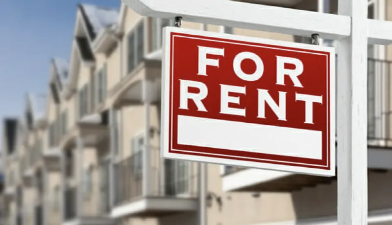 For Rent sign in front of Apartment Buildings
