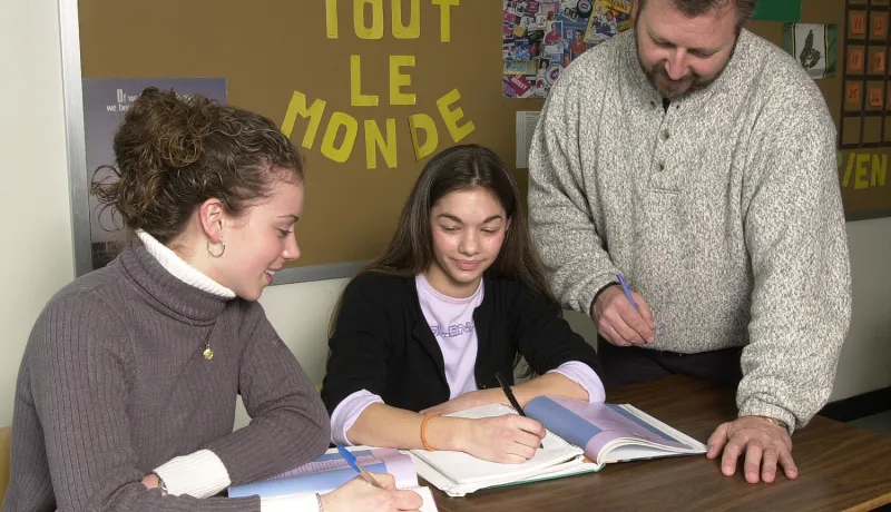 students looking at a book
