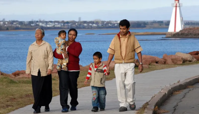 Multi-generational family walks on the boardwalk near Victoria Park
