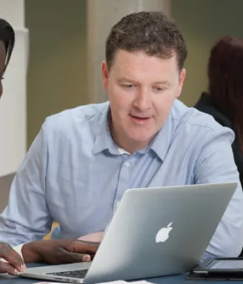 people looking at a computer