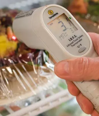 Digital thermometer reading temperature in food cooling unit
