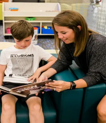Adult reading books to a child
