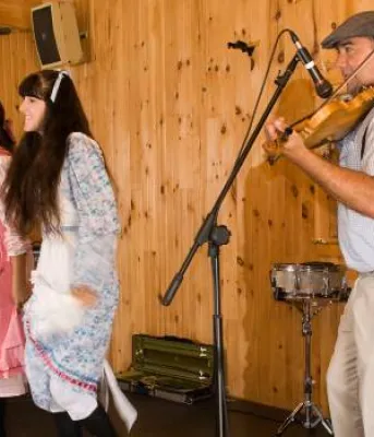 people dancing next to a fiddler