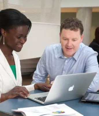 people looking at a computer