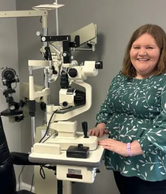 Dr. Wood pictured next to the mobile eye exam