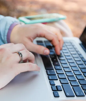 Image of person typing on a computer