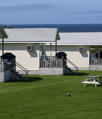 Three white cottages at waterfront in summer