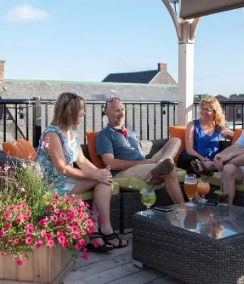 people sitting on an outside deck