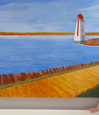 Kristy Peters, MRT, stands in front of mural at PEI Cancer Treatment Centre