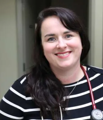 Nurse practitioner with a big smile in clinical setting on PEI