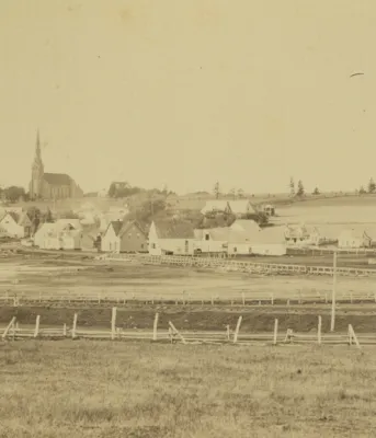 Community of St. Peters, PEI, ca. 1870-1880 Community of St. Peters, Prince Edward Island, ca. 1870-1880. A wooden bridge across the St. Peters Bay can be seen, as well as a church in the background. Several other buildings and structures are also visible. A small boat is in the lower left corner.