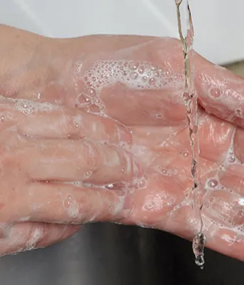 Image of female washing her hands