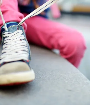 Back to school routines Image of small child tying shoe laces
