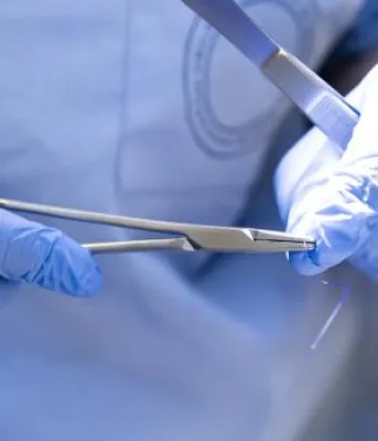 Surgeon holding tools