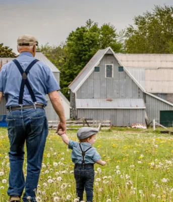Photo contest winning photo shows farmer and young child walking towards a barn