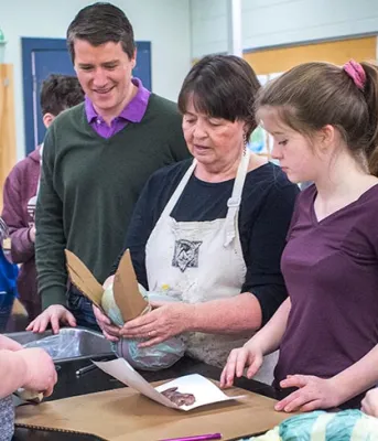 Teachers and artists bring curriculum to life for students through ArtsSmarts Three adults and two children looking at a person holding a paper mache animal.