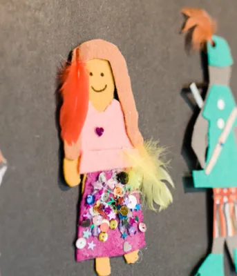 ArtsSmarts projects roll out across Island schools image of paper cutouts on a wall