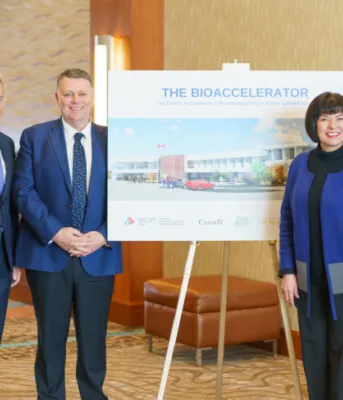 Growing Atlantic Canada’s biomanufacturing capacity image of people standing shoulder to shoulder in a hotel foyer with a sketch image of a new building in the middle of them