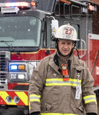 Image of Firefighter in front of firetruck