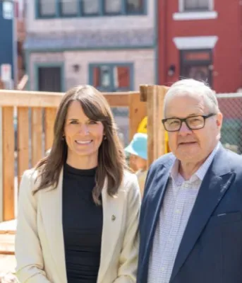 image of two people standing beside each other in a children&#039;s playground