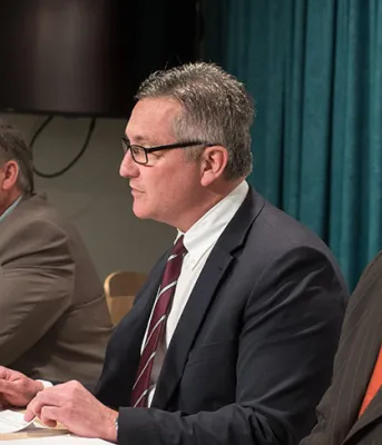 Photo shows ministers Robert Mitchell, Heath MacDonald, and Jordan Brown