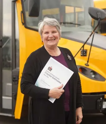 image of a person standing in front of a school bus