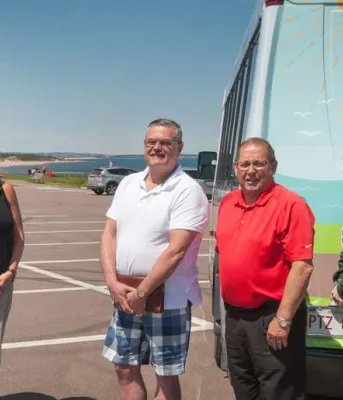 New bus service brings workers, visitors to the north shore People standing in front of Cit Beach bus