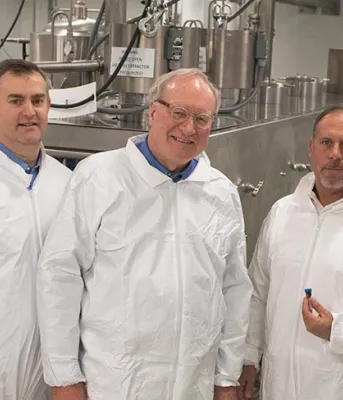 Province supports new jobs at cannabis processing facility Five people lined up beside each other in front of extraction equipment