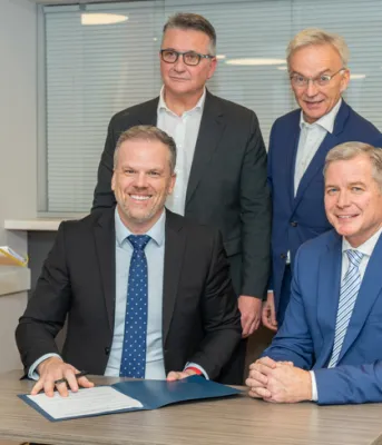 Canada signs $94 million bilateral agreement with Prince Edward Island to improve health care over three years image of five people at a table signing a document