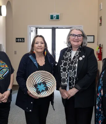 Four women smile next to each other