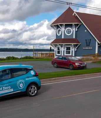 Province partners with Safe Drivers PEI so people can try out an electric vehicle image of an electric vehicle on a street with a building and a bay in the background