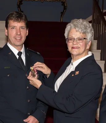 Photo shows Lieutenant Governor Antoinette Perry presenting advanced care paramedic Terrance MacPherson with the award with Minister Robert Henderson and Island EMS general manager Darcy Clinton.  