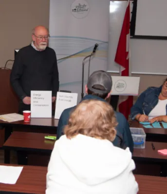 Feedback shows Islanders are focused on clean, affordable and reliable energy image of people sitting at some tables having a discussion