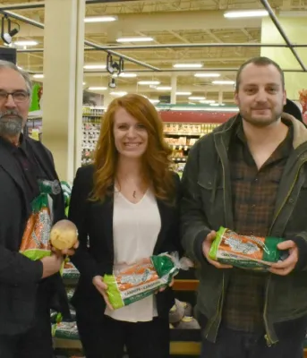 From farm to table, and everwhere in between Photos shows five people holding bags of produce