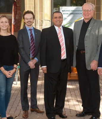 Federal Provincial infrastructure funding announcement at UPEI Premier macLauchlan and Minister Richard Brown along with 5 other people stand in front of Dalton Hall on the UPEI campus.