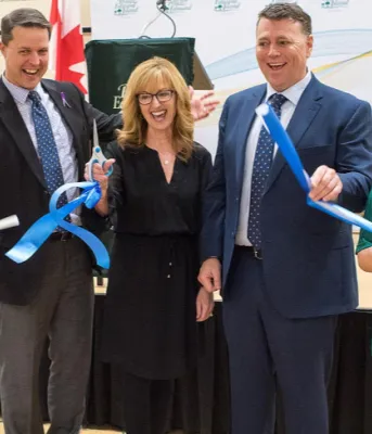 People in a row cutting an official opening ribbon