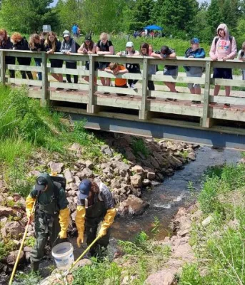 Watershed group making a difference in the Hunter River area ecosystem for 25 years Image of group of people on small bridge looking over at watershed