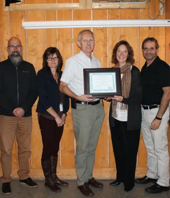 Bonshaw Hills committee honored by planners group Photo shows Alex Forbes in the centre holding the award certificate flanked by six subcommittee members.